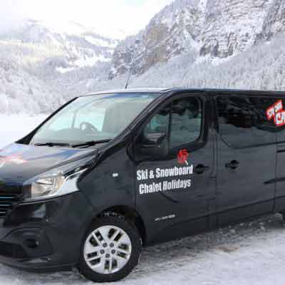 morzine airport transfer minibus with snowy mountain backdrop